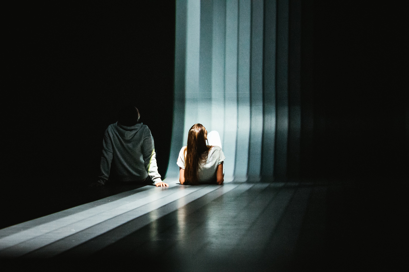 A couple of friends sitting by the light and shadow