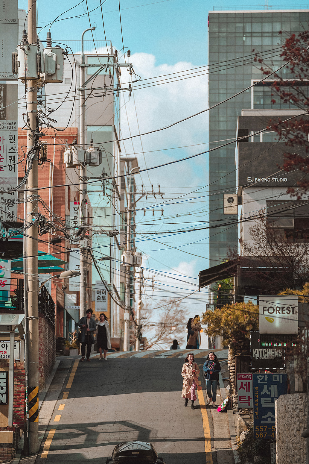 Two women walking at road during daytime
